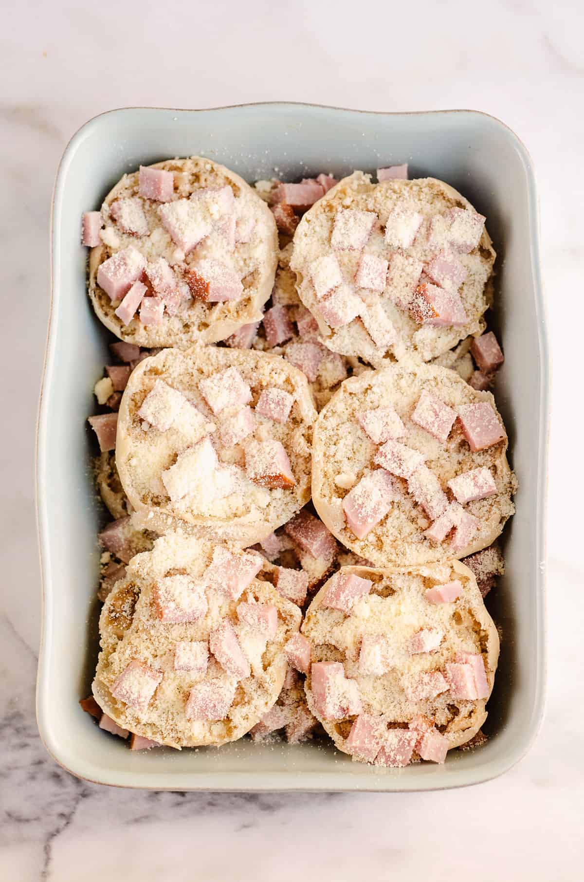 ham and parmesan on english muffins in pan