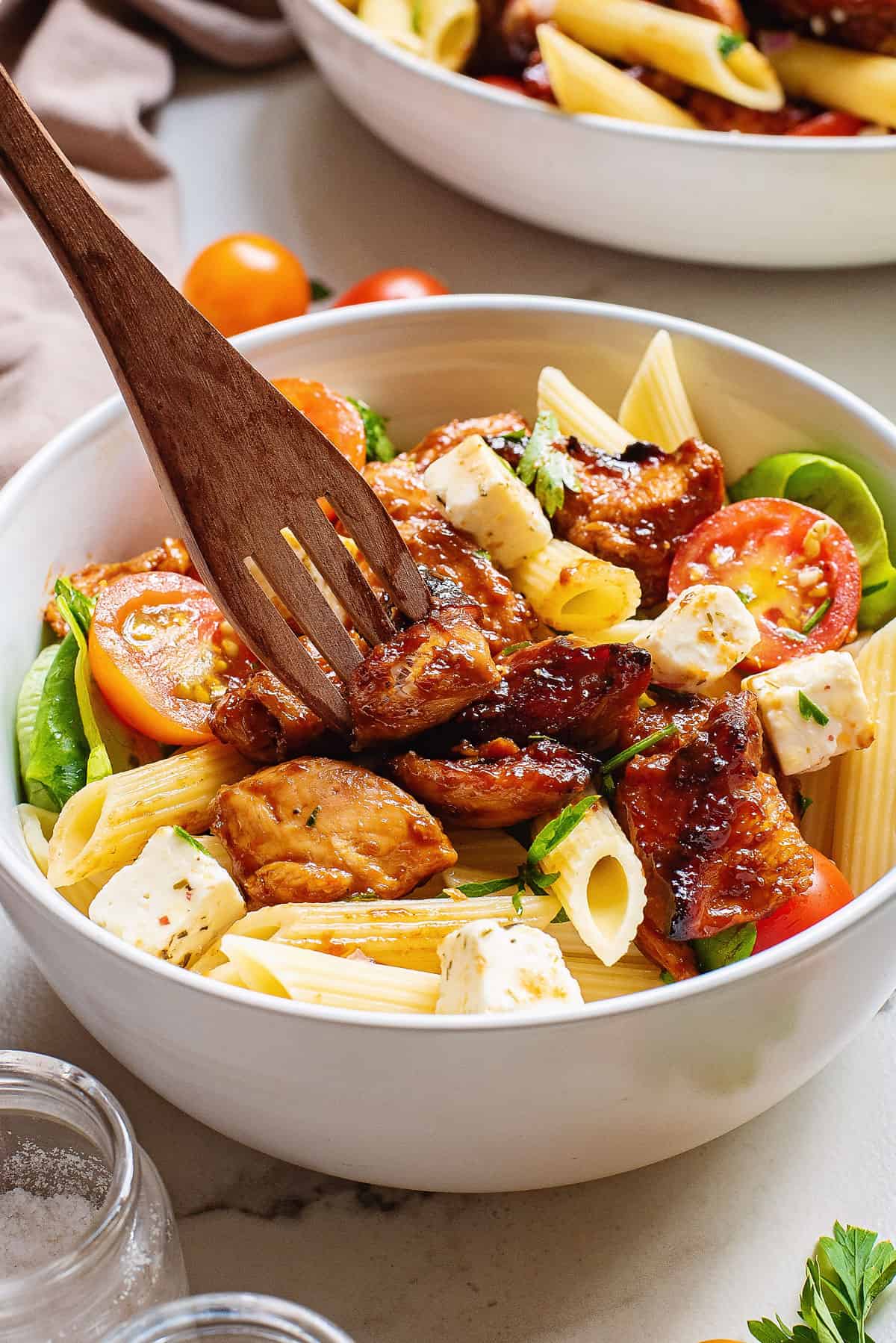 fork in bowl of bbq pasta salad