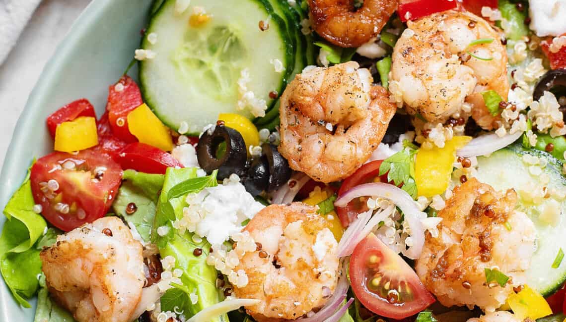 Greek salad with shrimp and vegetables in large bowl