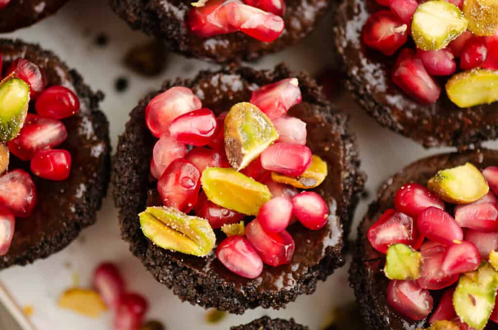 Mini Pomegranate Chocolate Tarts on serving board