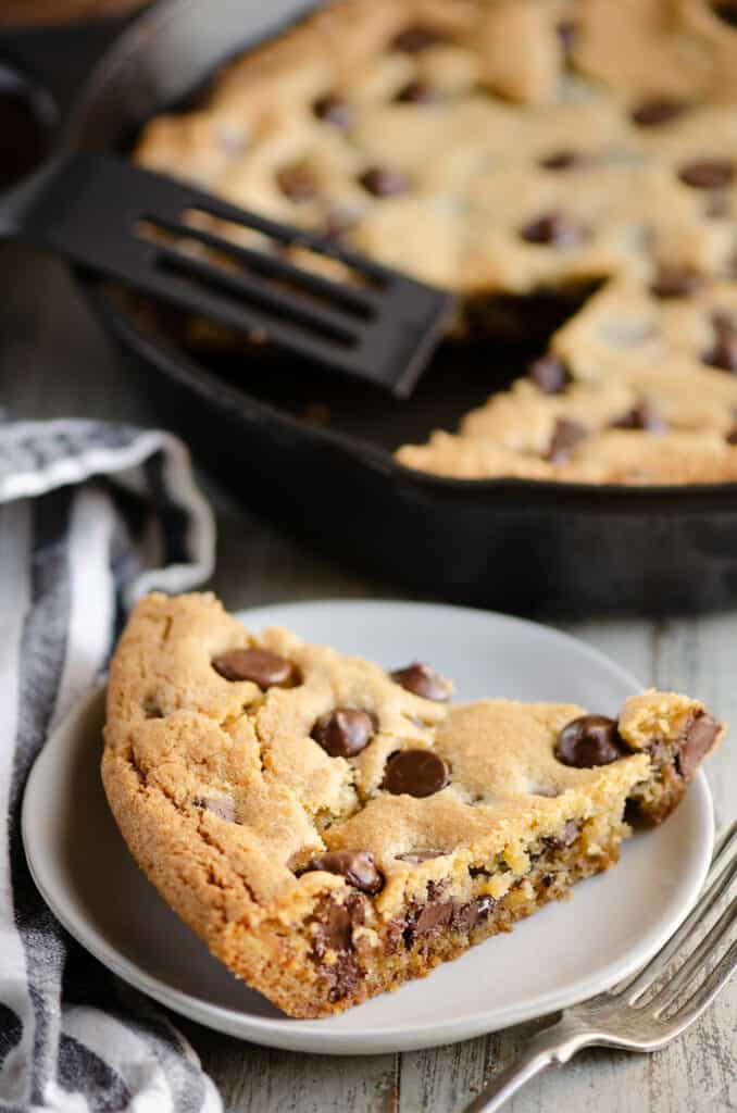 piece of chocolate chip cookie skillet on plate with pan