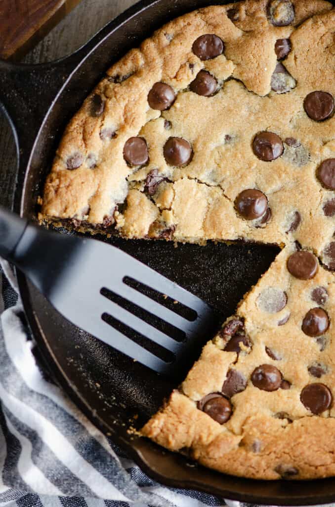 small spatula in pan of chocolate chip cookie skillet