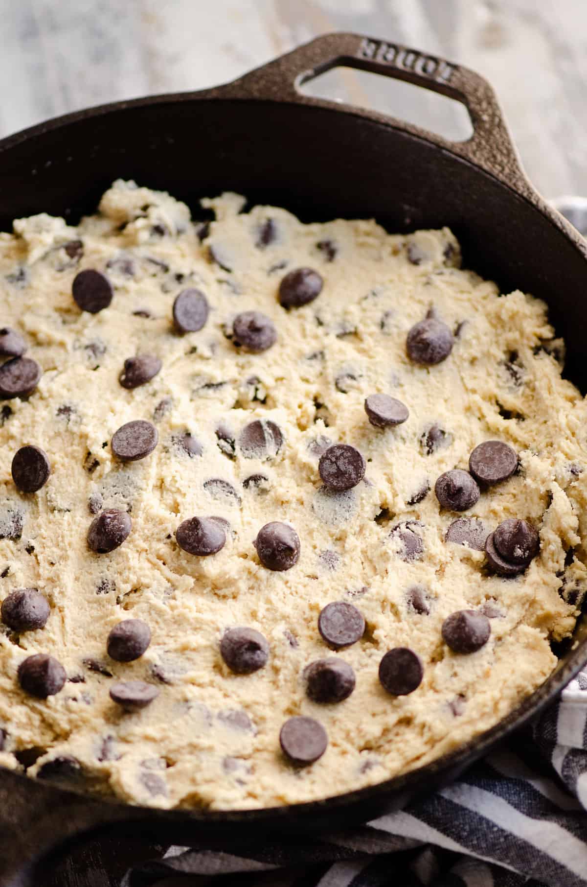 chocolate chip cookie dough pressed in cast iron skillet