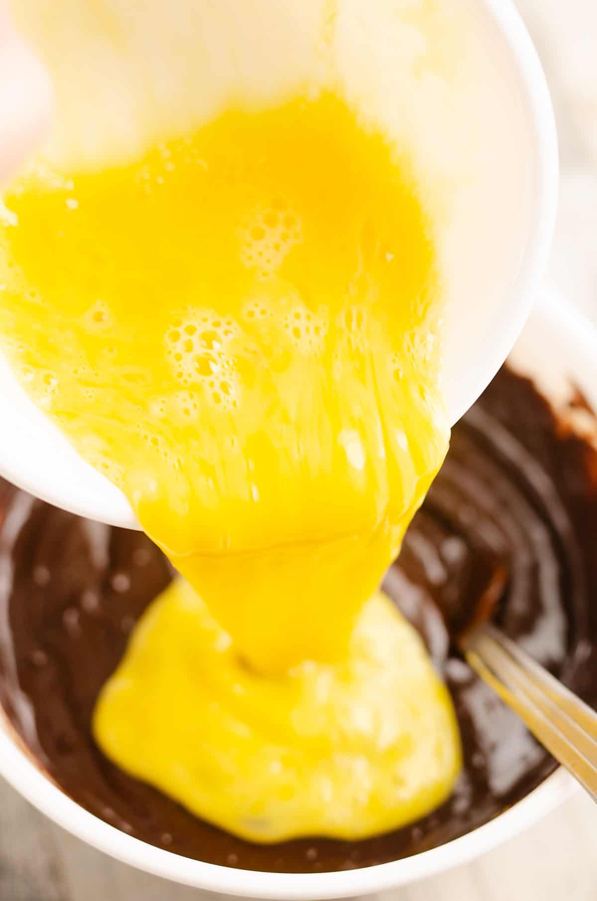 eggs poured into chocolate ganache for filling