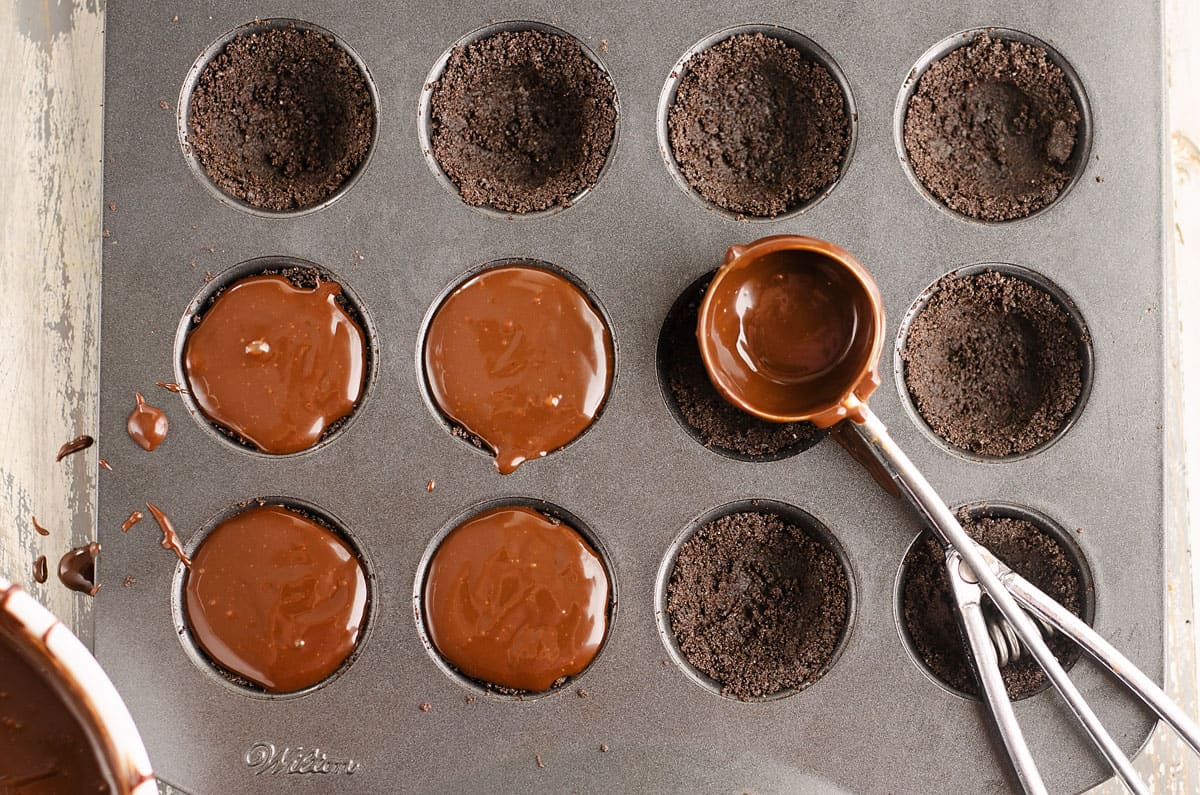 chocolate ganache scooped into mini chocolate tarts