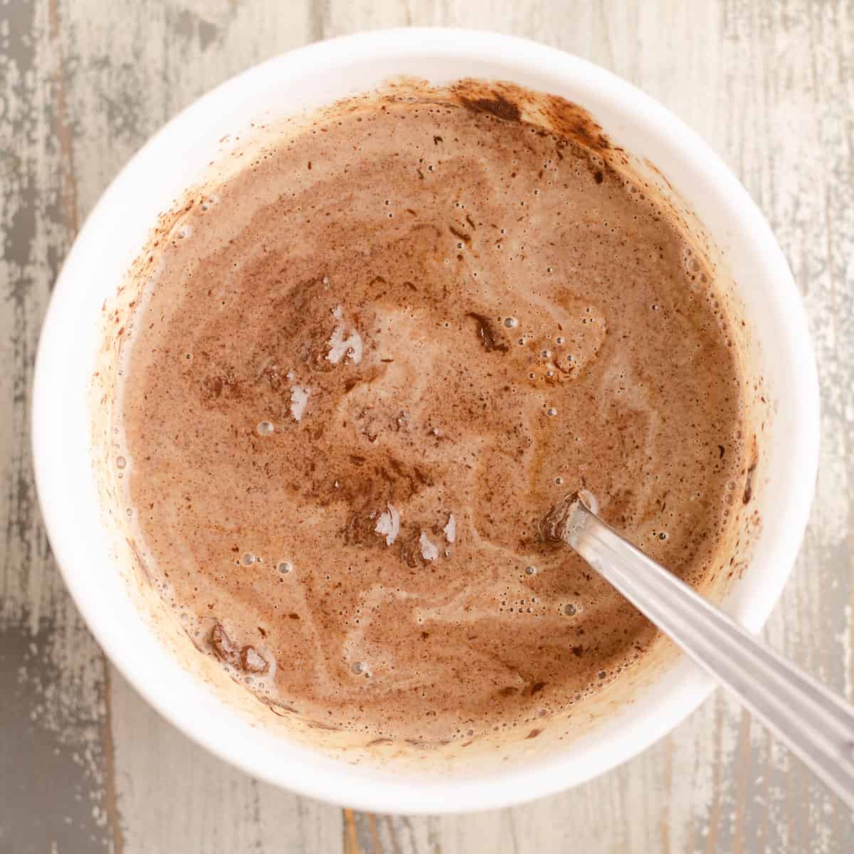 chocolate chips and cream mixed in bowl