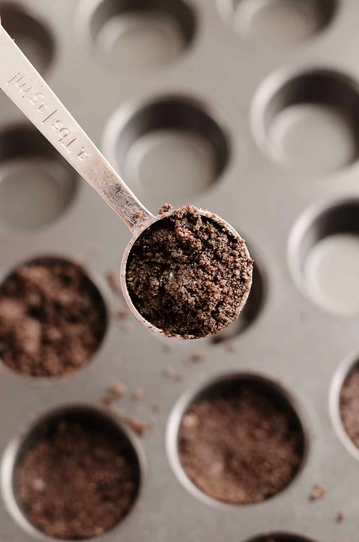 cookie crust scooped in measuring spoon