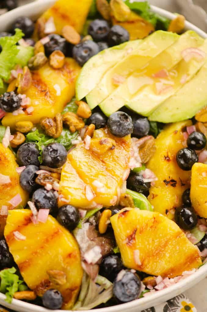 Grilled Pineapple salad topped with white balsamic shallot vinaigrette