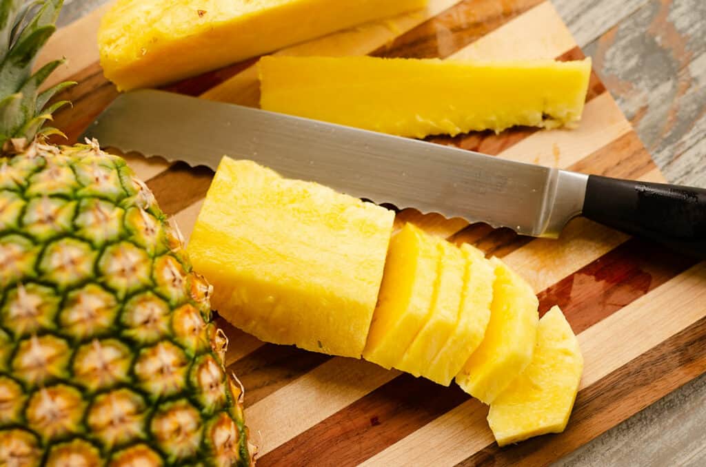 sliced fresh pineapple on cutting board