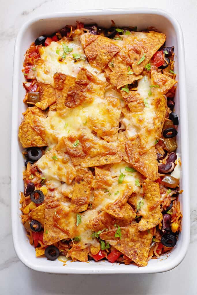 Cheesy Dorito casserole in white pan on table