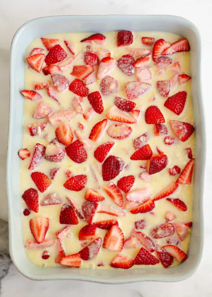 strawberries covered in custard in pan