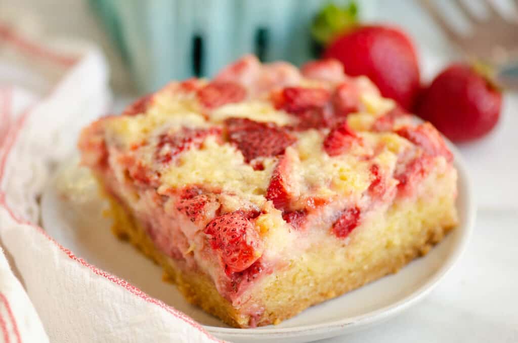 piece of strawberry custard dessert on plate with napkin