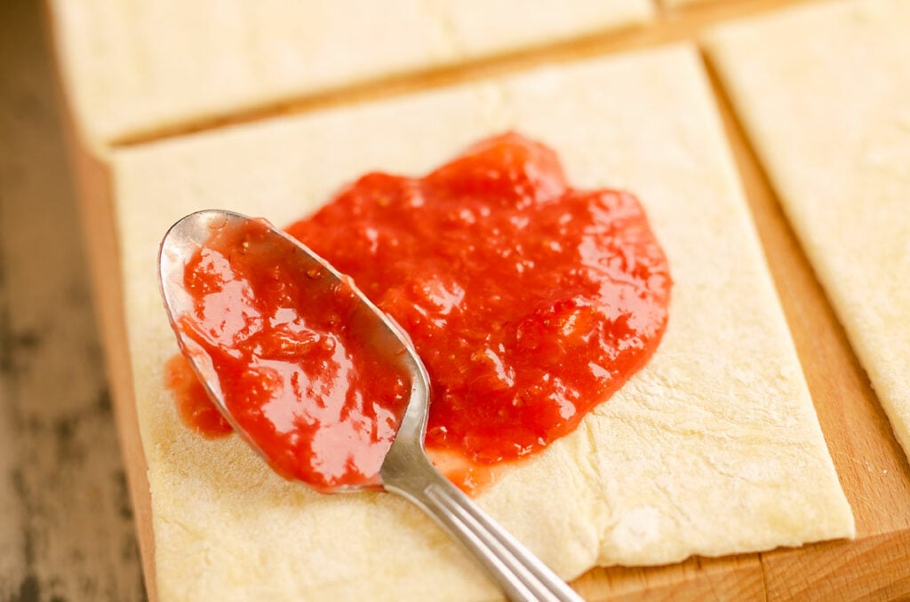 strawberry rhubarb sauce spooned on puff pastry