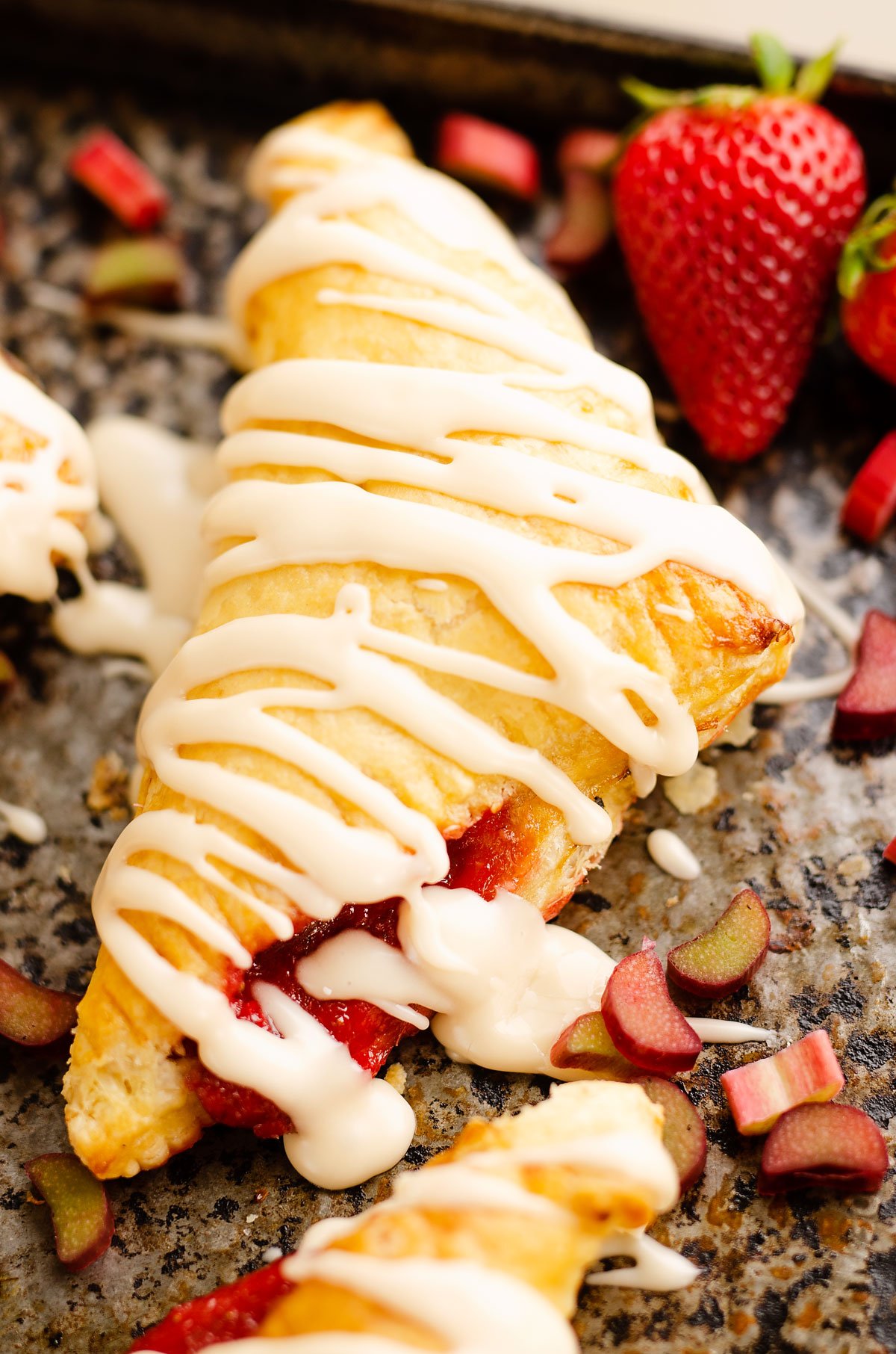 rhubarb turnover on baking sheet with strawberry