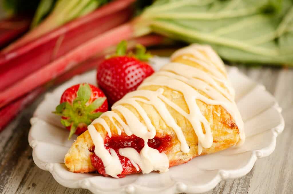 rhubarb turnover on plate with strawberries