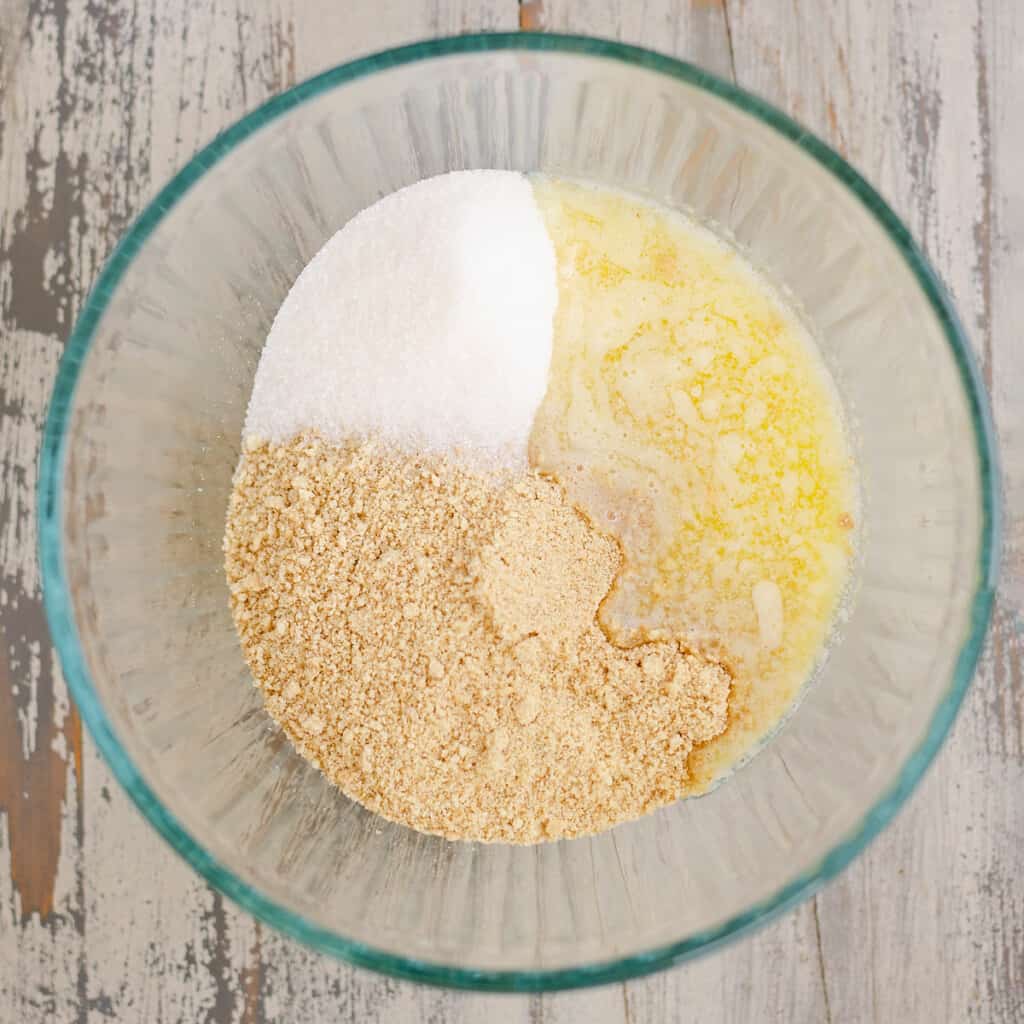 graham crackers, butter and sugar in bowl