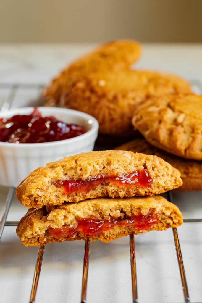 peanut butter cookies stuffed with jelly on cooling rack