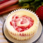 strawberry rhubarb mini cheesecakes on plate with fresh produce