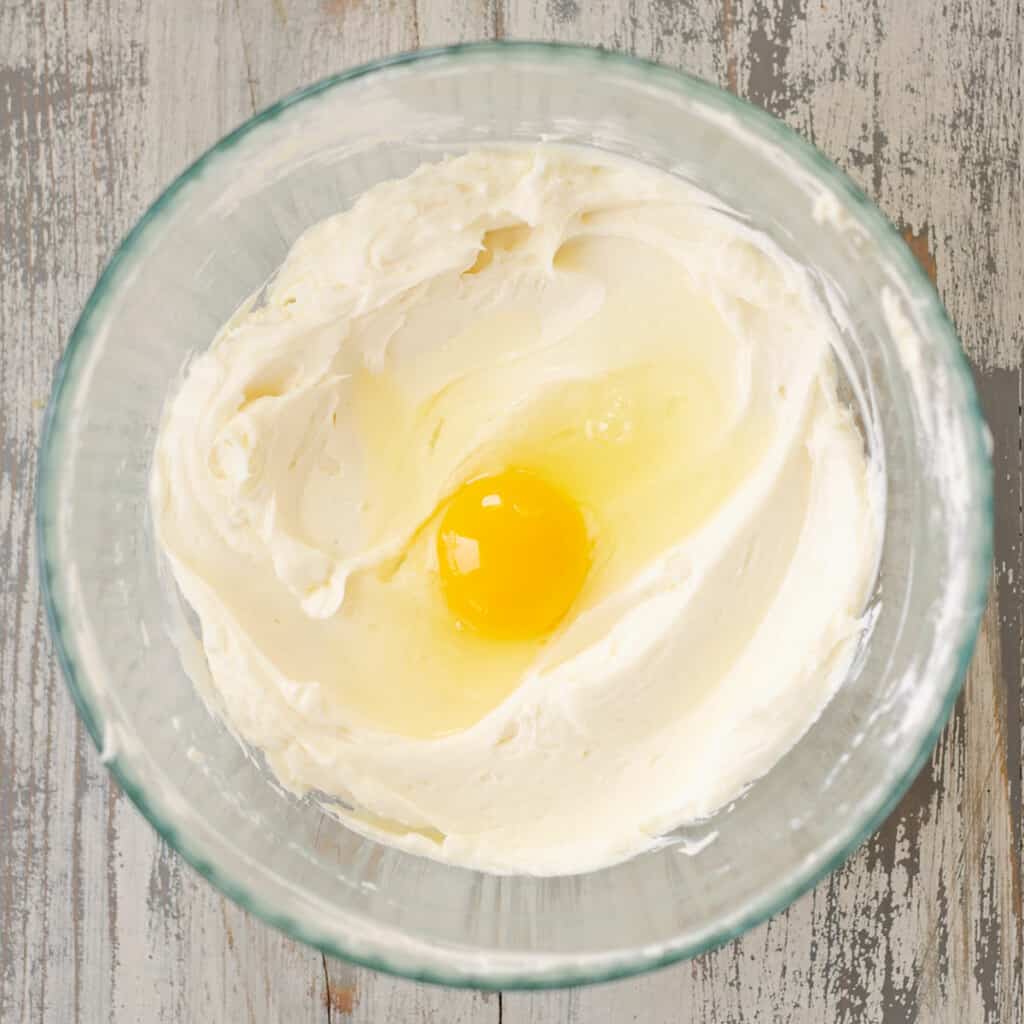 egg mixed into cheesecake mixture
