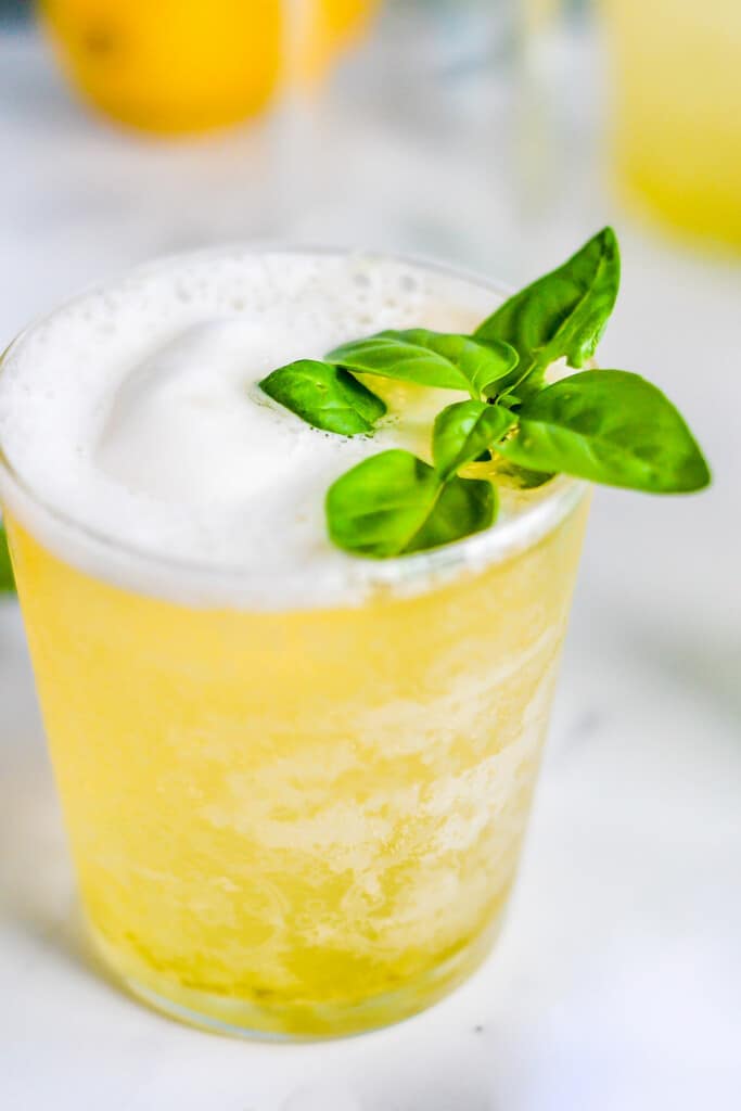 chilled lemon lime sorbet punch in glass topped with basil