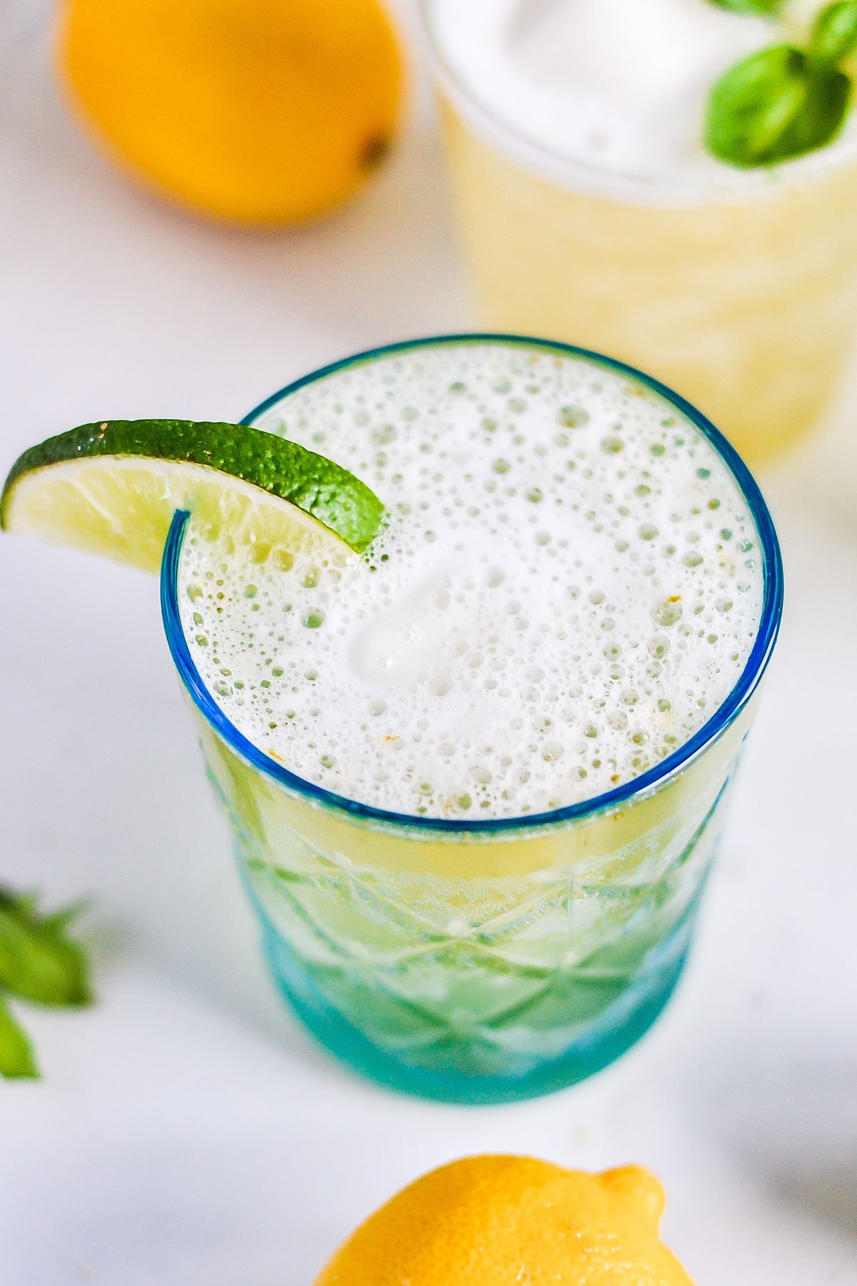 lemon lime sorbet punch in etched glass on table with citrus