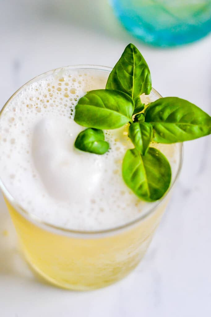 fresh basil on top of lemon sorbet punch glass