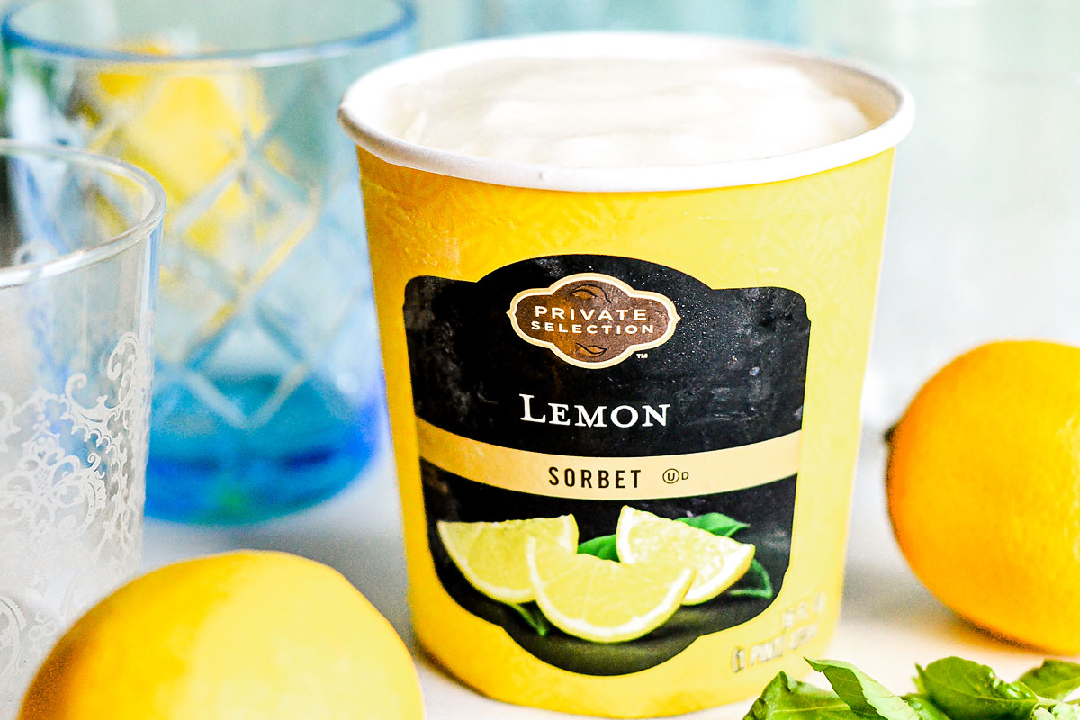 pint of lemon sorbet with fresh lemons