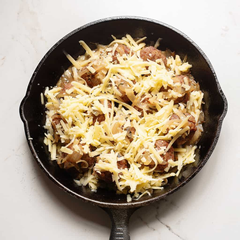 meatballs topped with onions and cheese