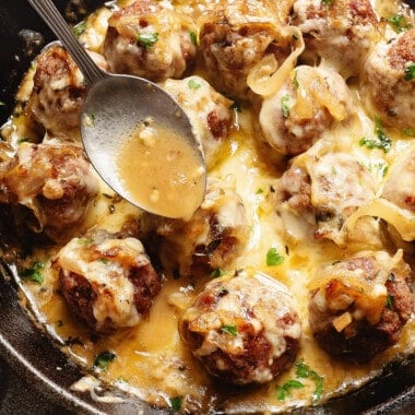 spoonful of french onion sauce over meatballs