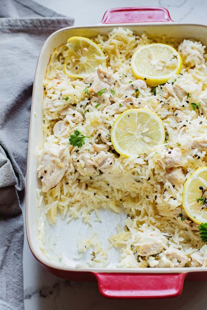 fluffy rice and lemon chicken in baking pan on table