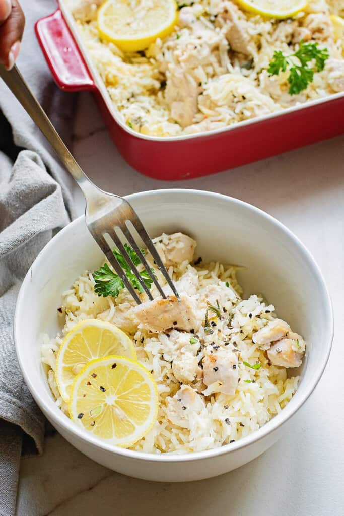 fork in bowl of lemon chicken and rice