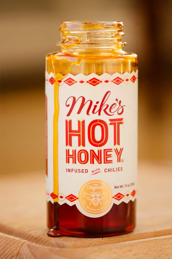 Mike's Hot Honey Jar with honey dripping down