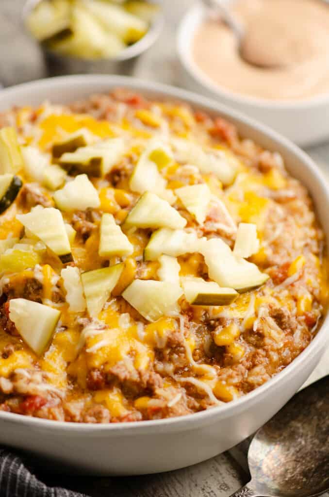 Instant Pot cheeseburger casserole in bowl topped with pickles