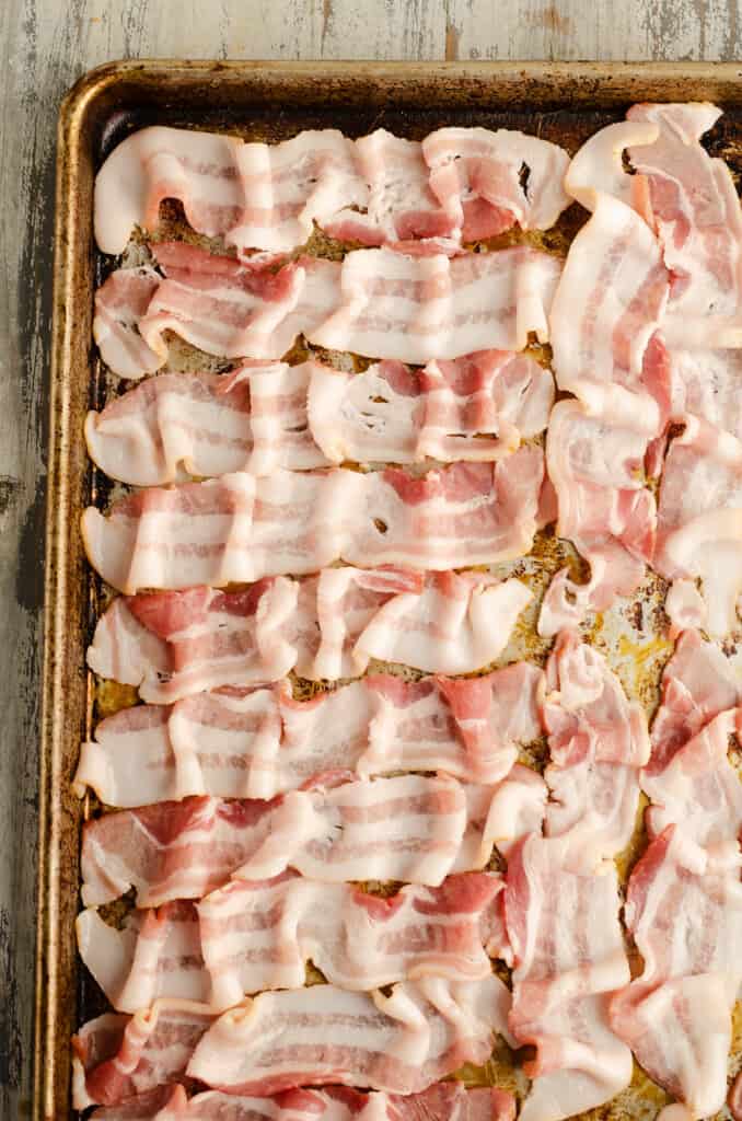 bacon slices arranged on sheet pan