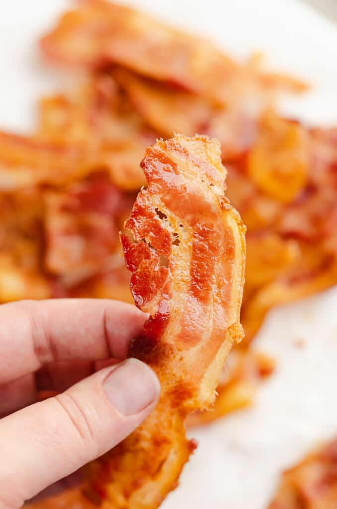 baked bacon in hand