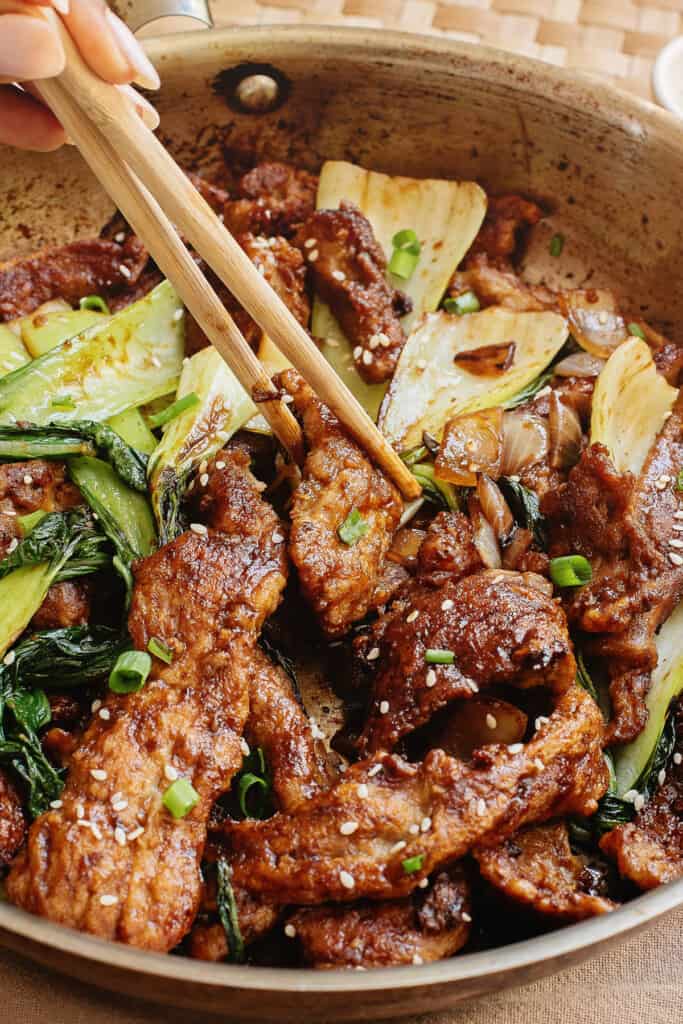 Beef and Bok choy in oyster sauce in pan with chop sticks