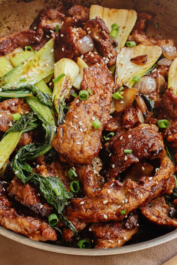 Beef in oyster sauce in pan with Bok choy and onions