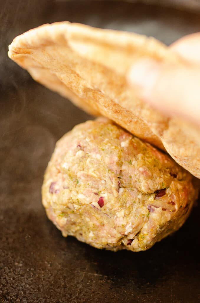 ground lamb and onion smashed on blackstone with pita bread