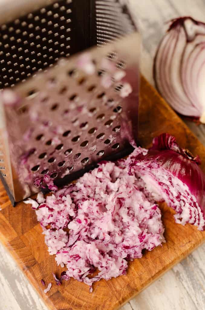 grated onion on cutting board