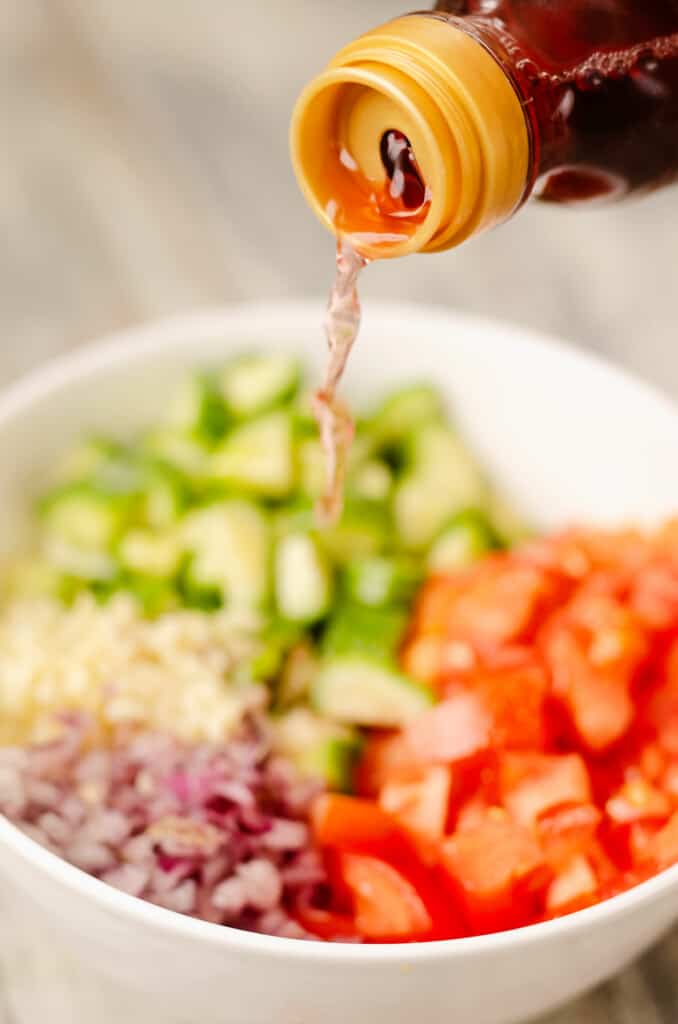 tomato cucumber salad with with a drizzle of red wine vinegar