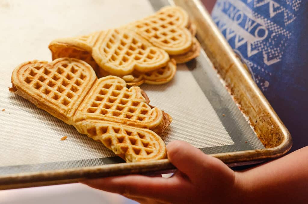 boy holding pan of folded nordic waffles