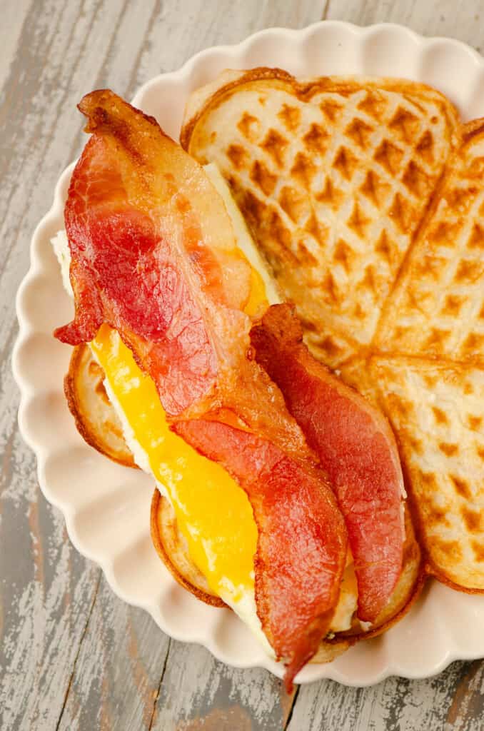 nordic waffle topped with cheesy eggs and bacon
