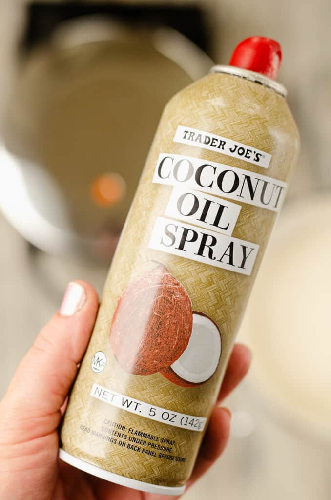 coconut oil spray can in hand