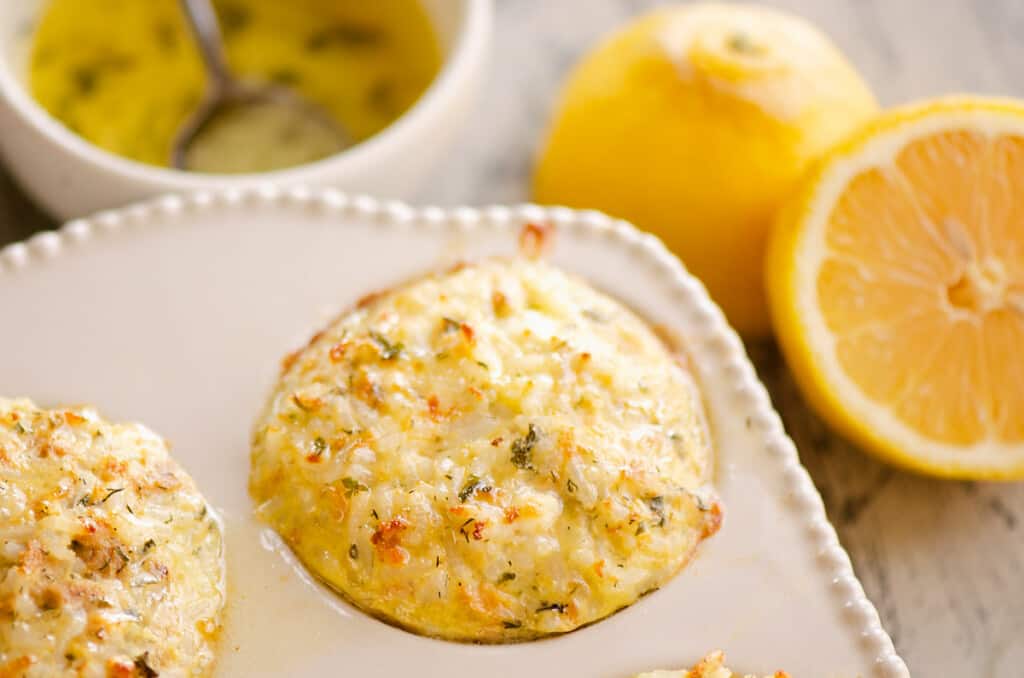 salmon rice muffins in pan with lemon and butter sauce on table