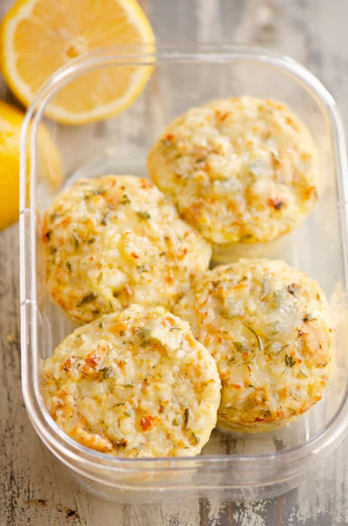 salmon rice muffins in meal prep container with lemon half