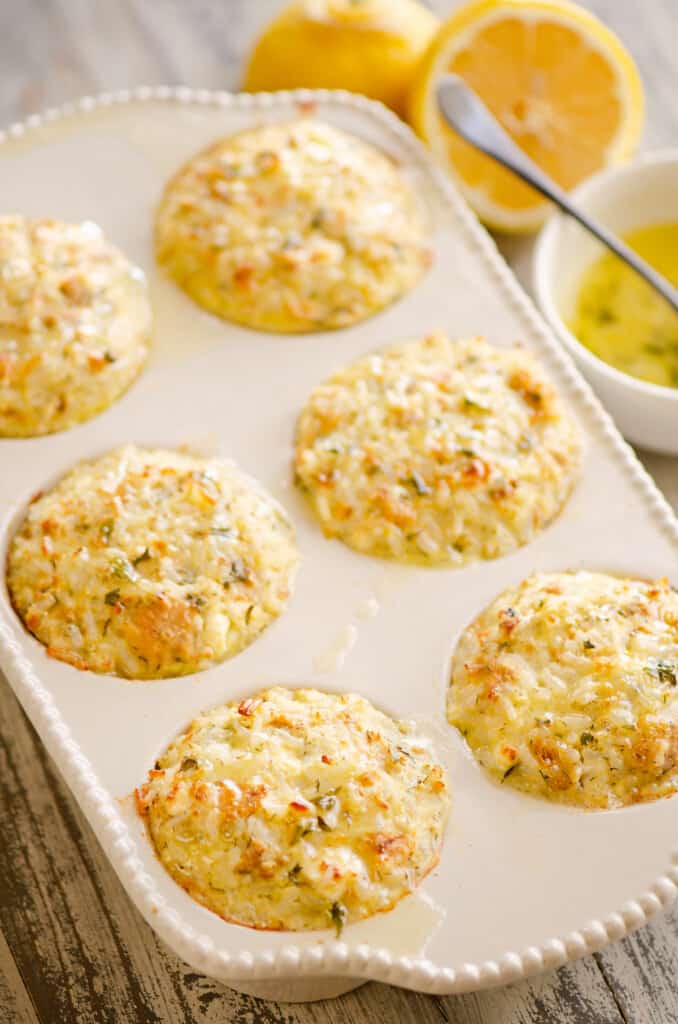 salmon rice muffins in pan on table with lemon and butter sauce