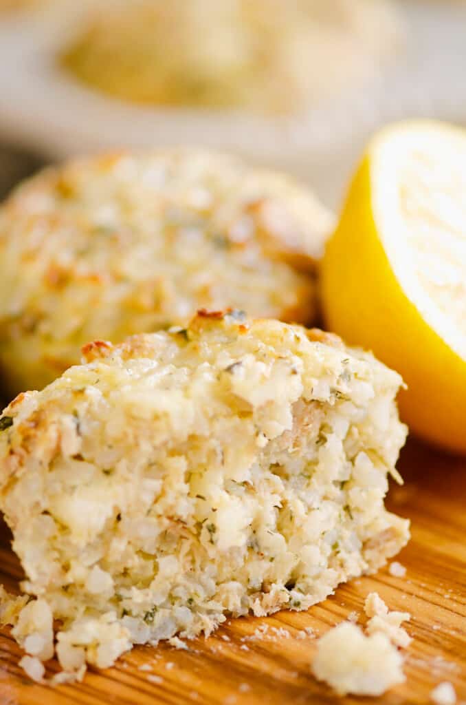 half of salmon rice muffin on board with lemon